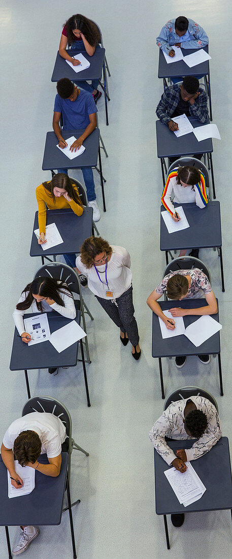 Teacher supervising students taking exam