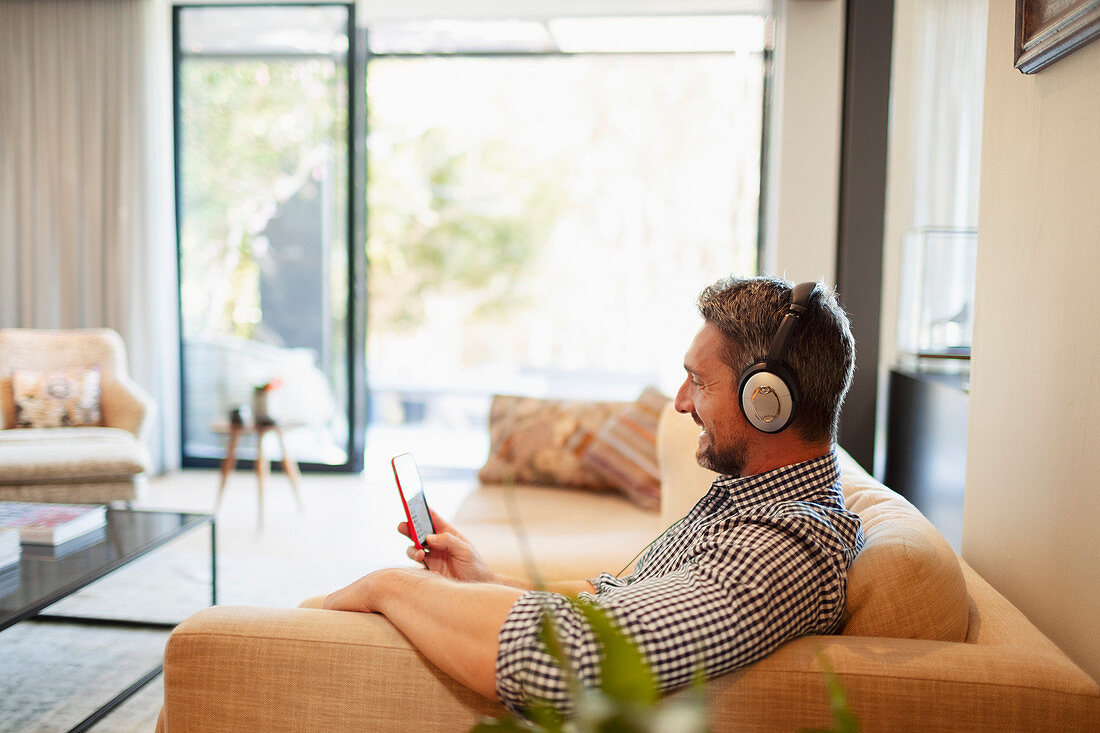 Man and mp3 player listening to music at home
