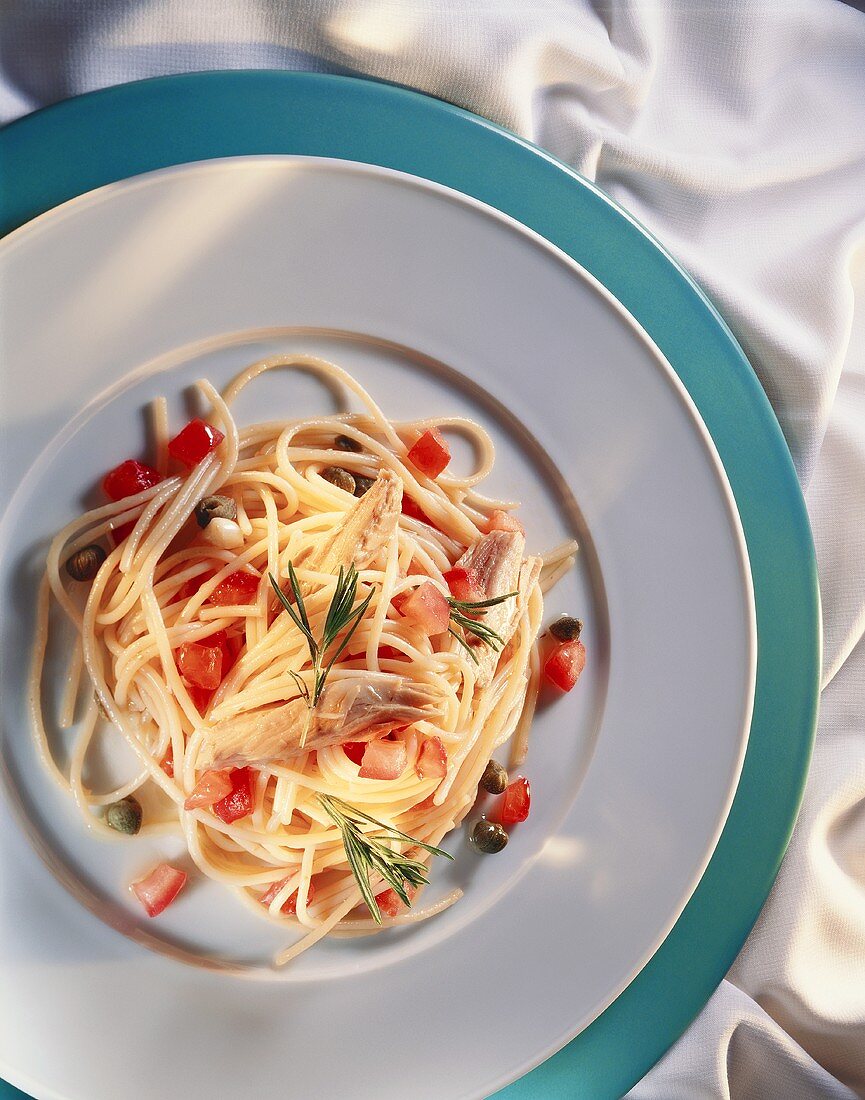 Spaghetti with tuna, tomatoes and capers on plate