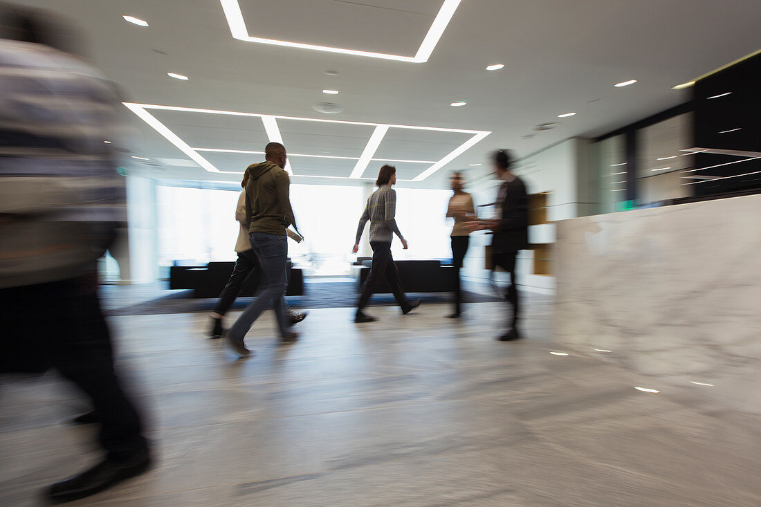 Business people walking in office lobby