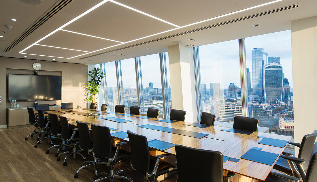 Long modern conference room table overlooking city