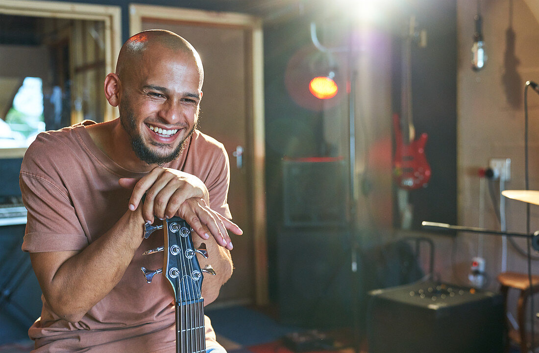 Happy male musician in recording studio