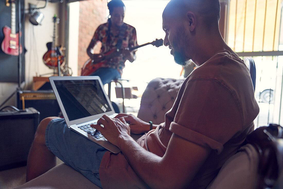 Musicians with laptop and guitar