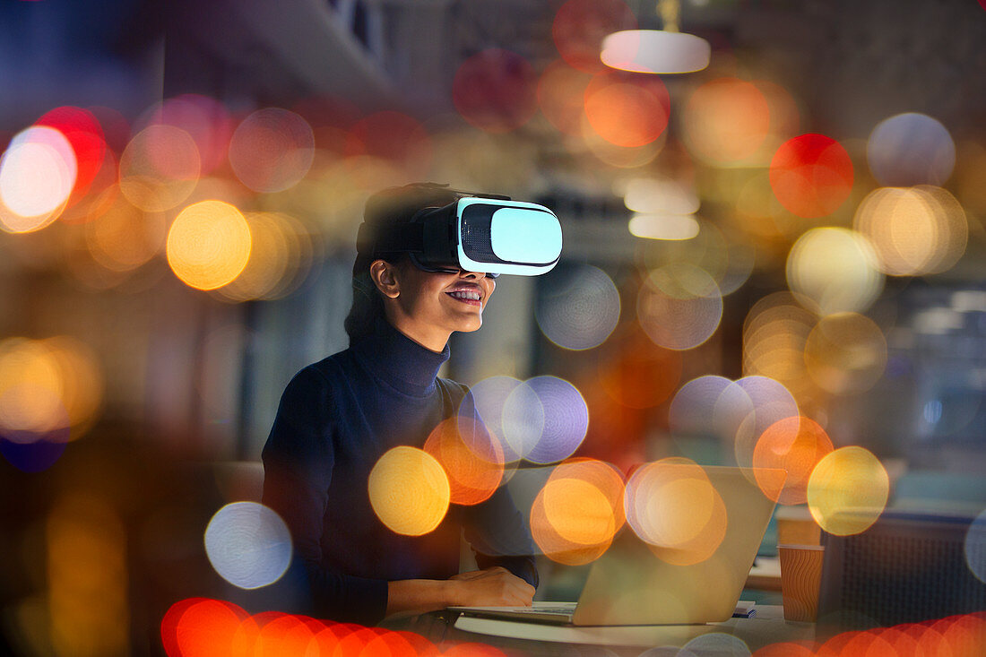 Smiling businesswoman using VR glasses