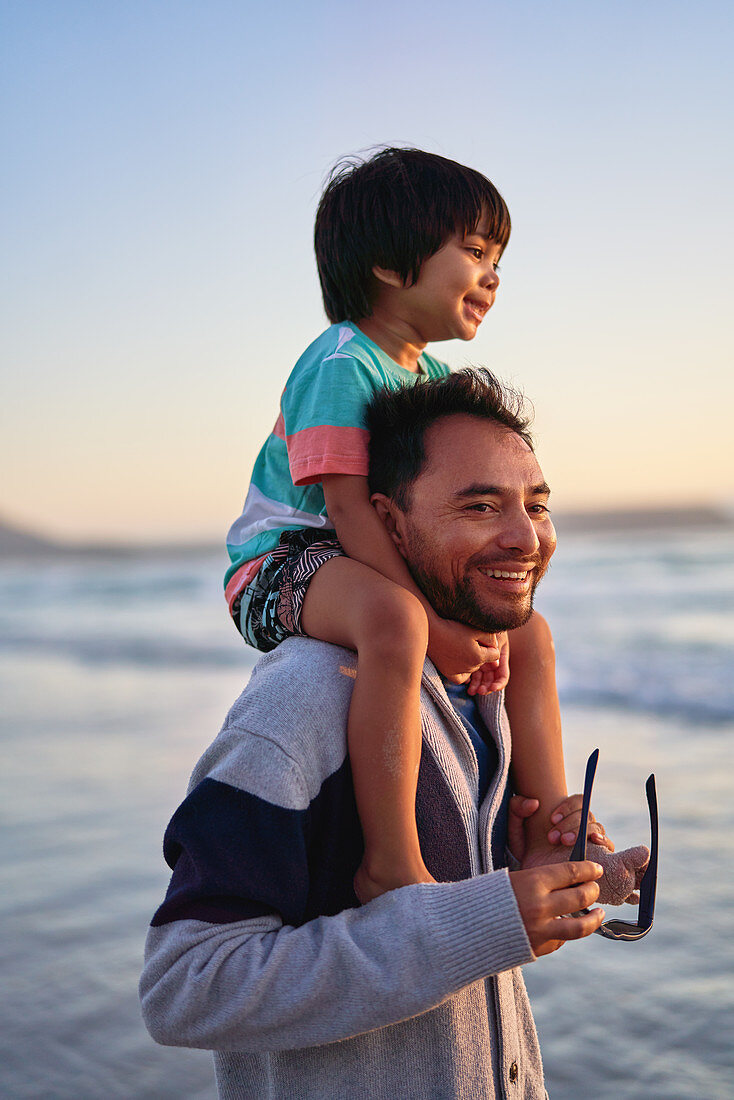 Father carrying son on shoulders