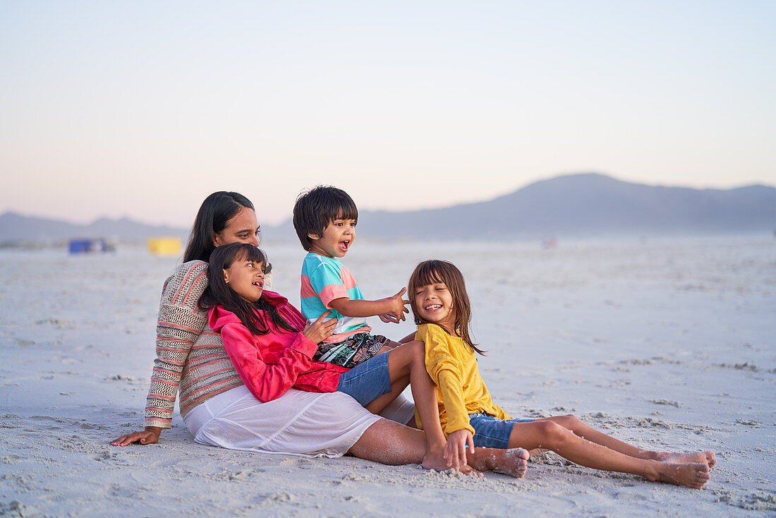 Happy family relaxing on beach