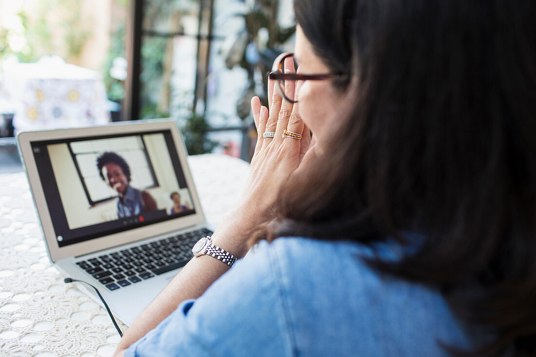 Woman video conferencing with colleagues