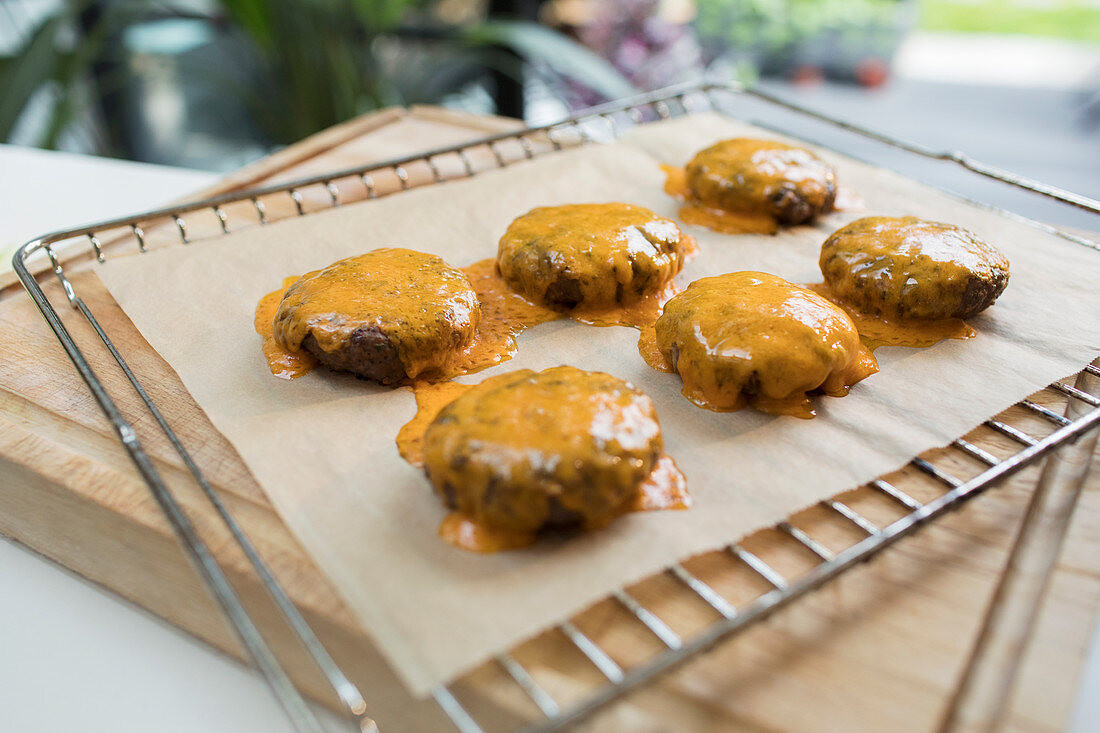 Close up cheeseburgers on cooling rack