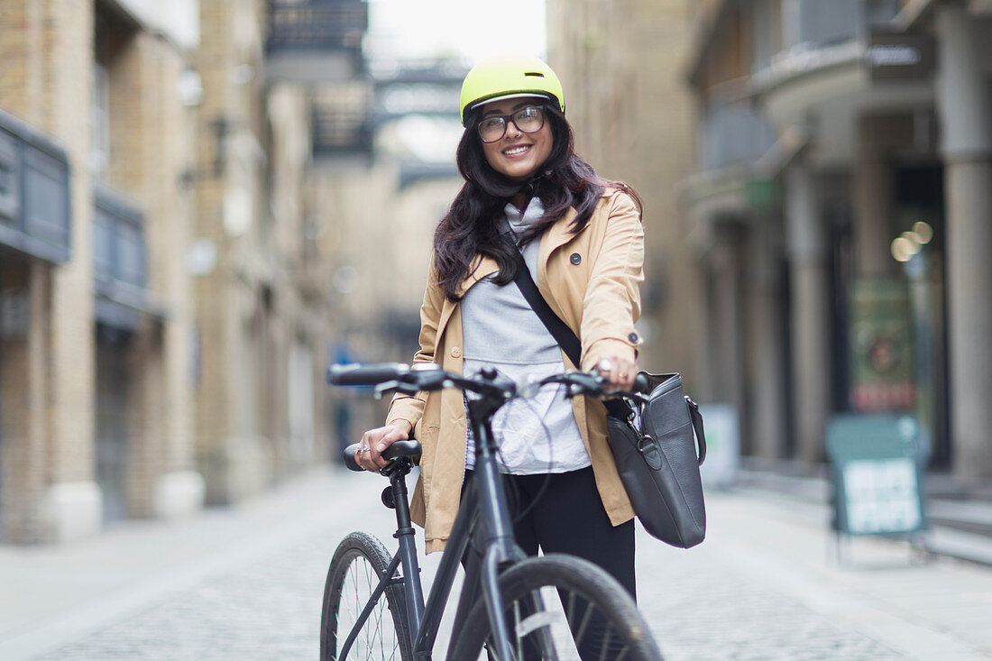 Portrait woman in helmet with bicycle