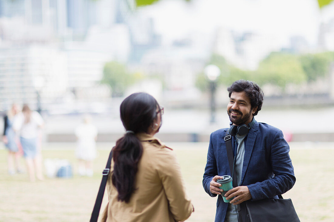 Business people talking in city park