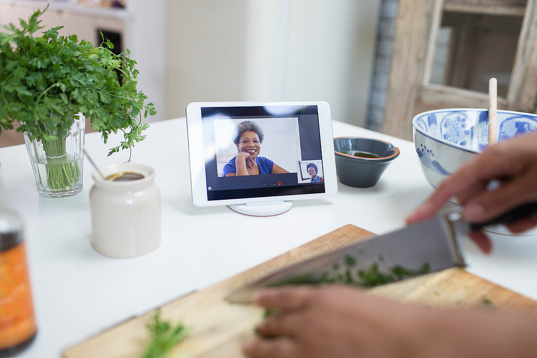 Woman cooking and video chatting