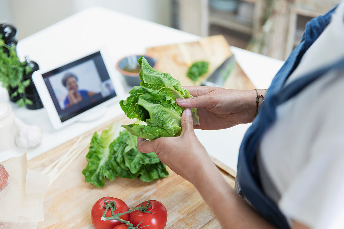 Woman cooking and video chatting