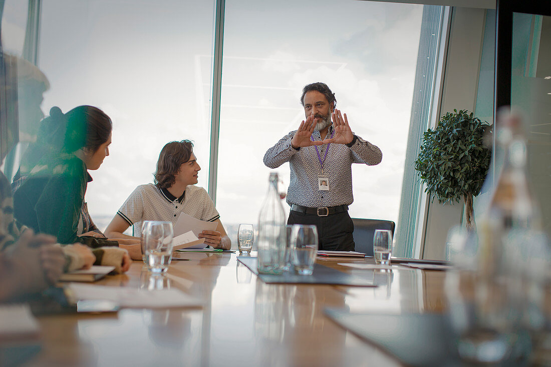 Businessman leading conference room meeting