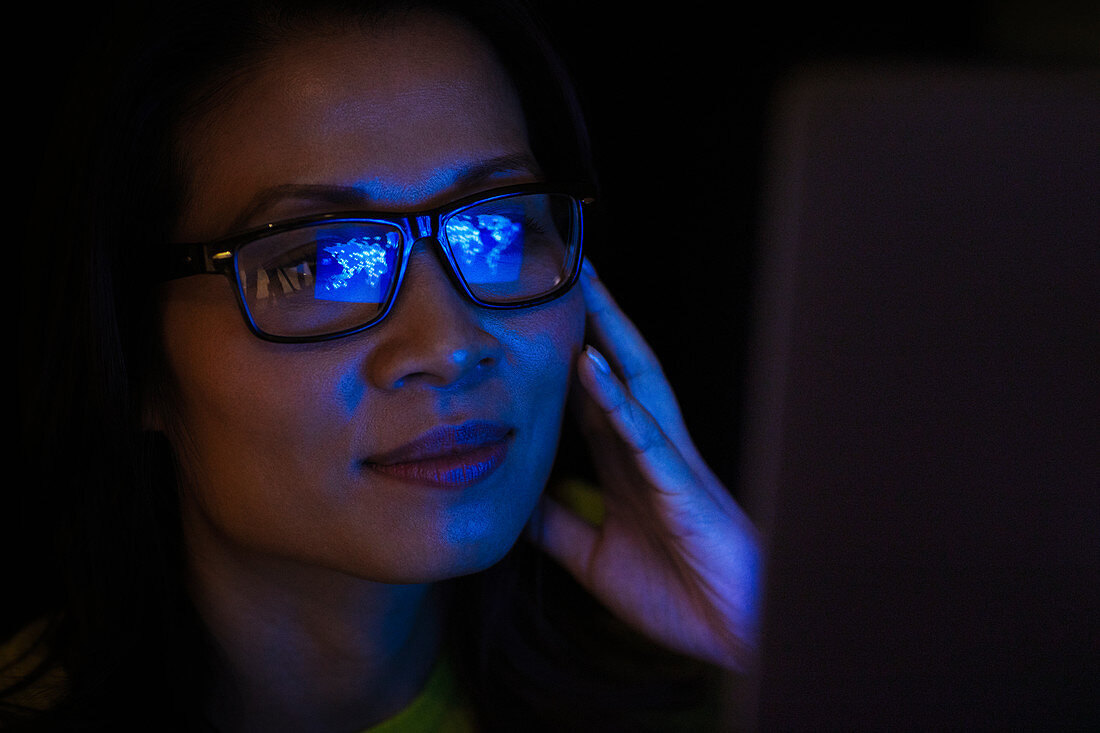Laptop reflection in eyeglasses of businesswoman