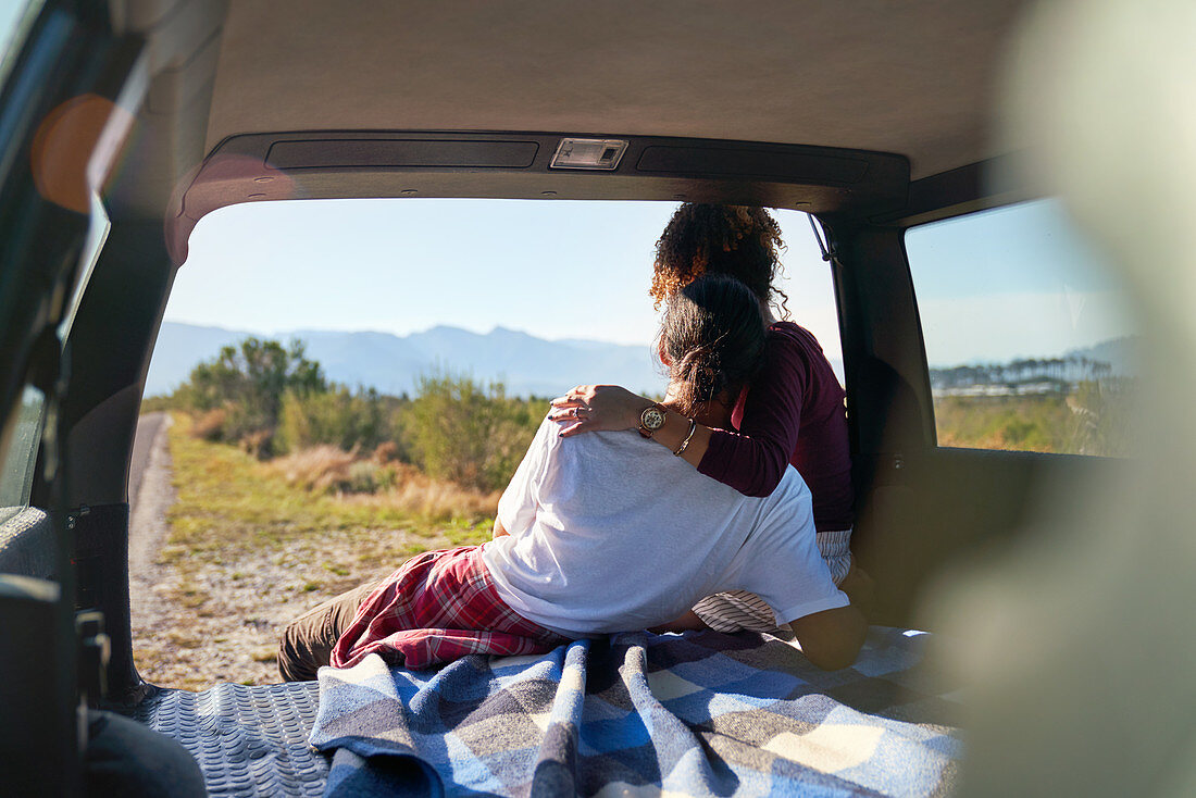 Couple enjoying nature view from back of car