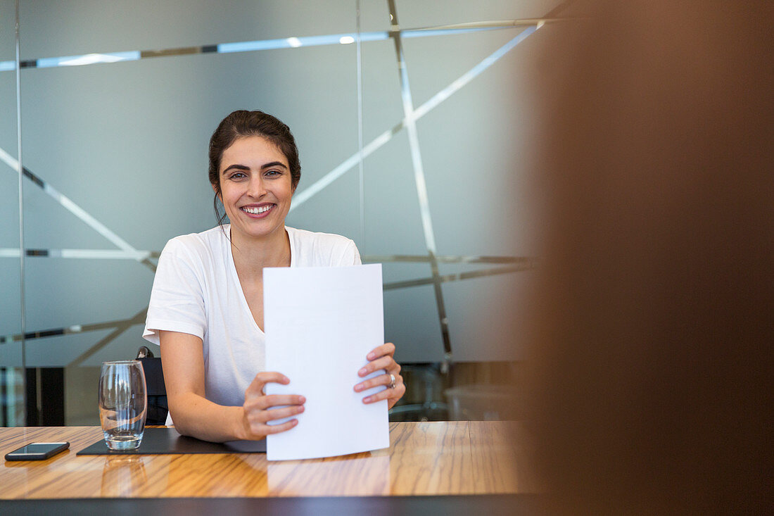 Portrait Businesswoman with paperwork in meeting