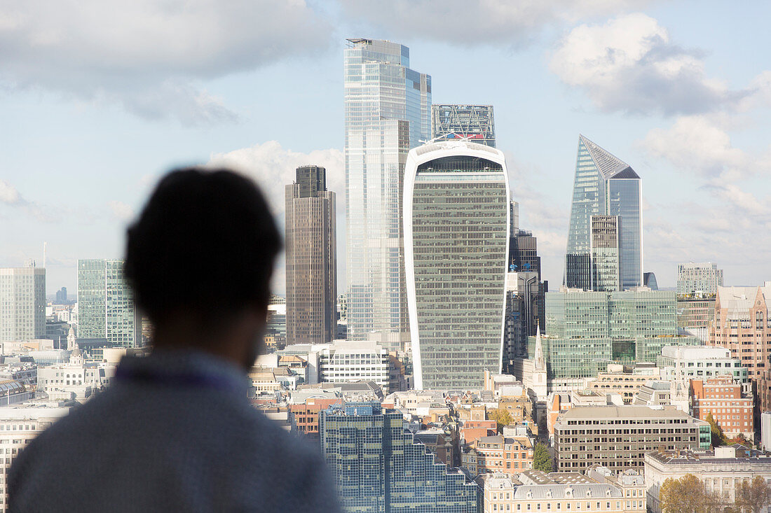 Businessman looking at London cityscape, UK