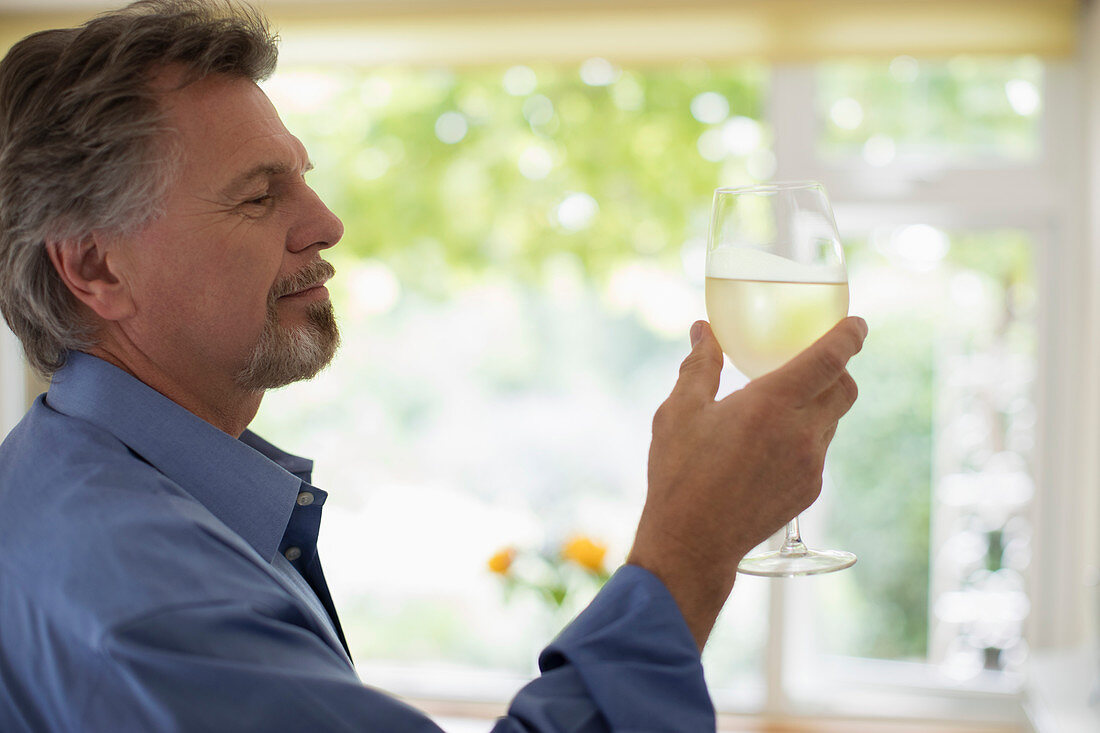 Senior man drinking white wine