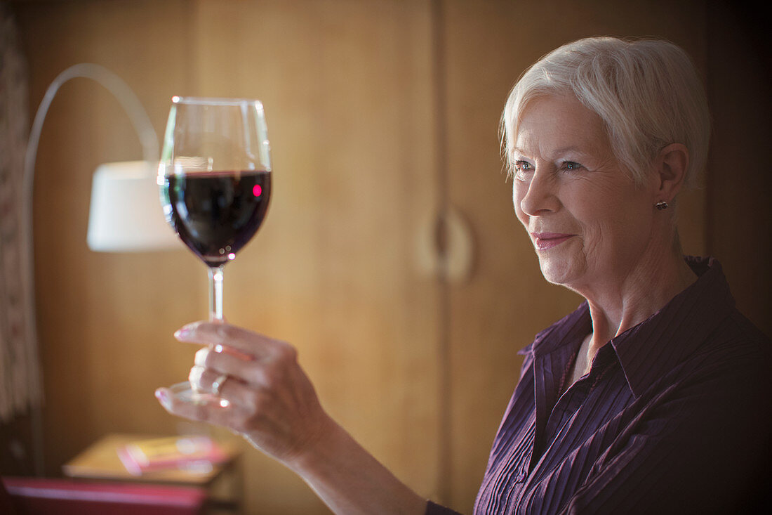Senior woman enjoying red wine