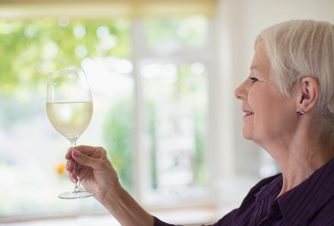 Senior woman drinking white wine