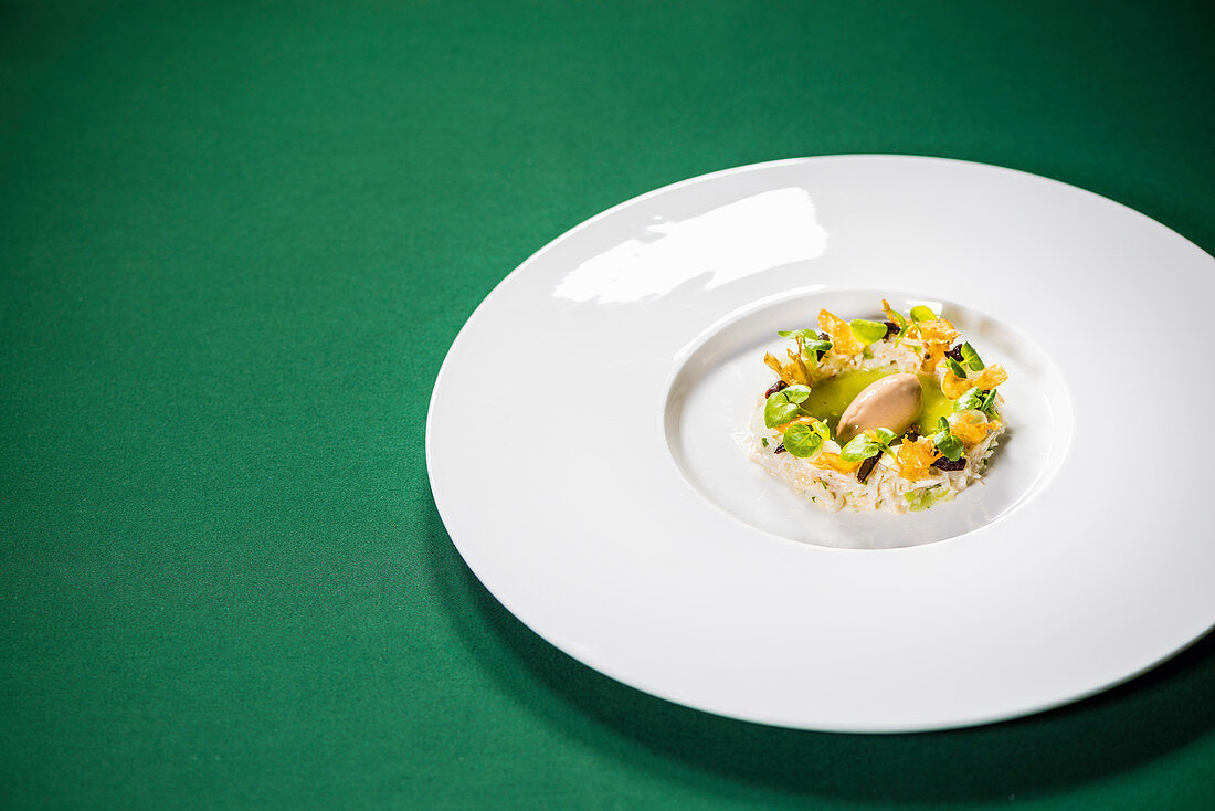 Edible crab salad and duck liver rice with olives and artichoke chips