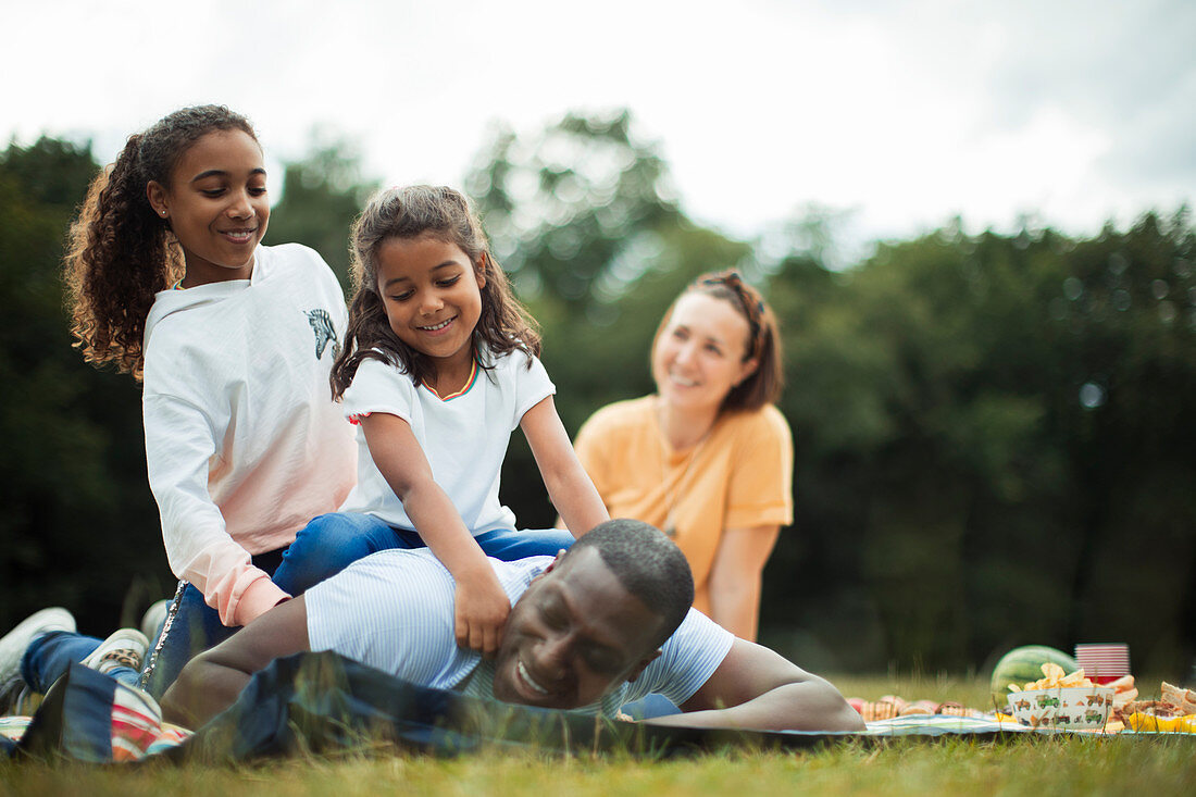 Happy family enjoying picnic in park