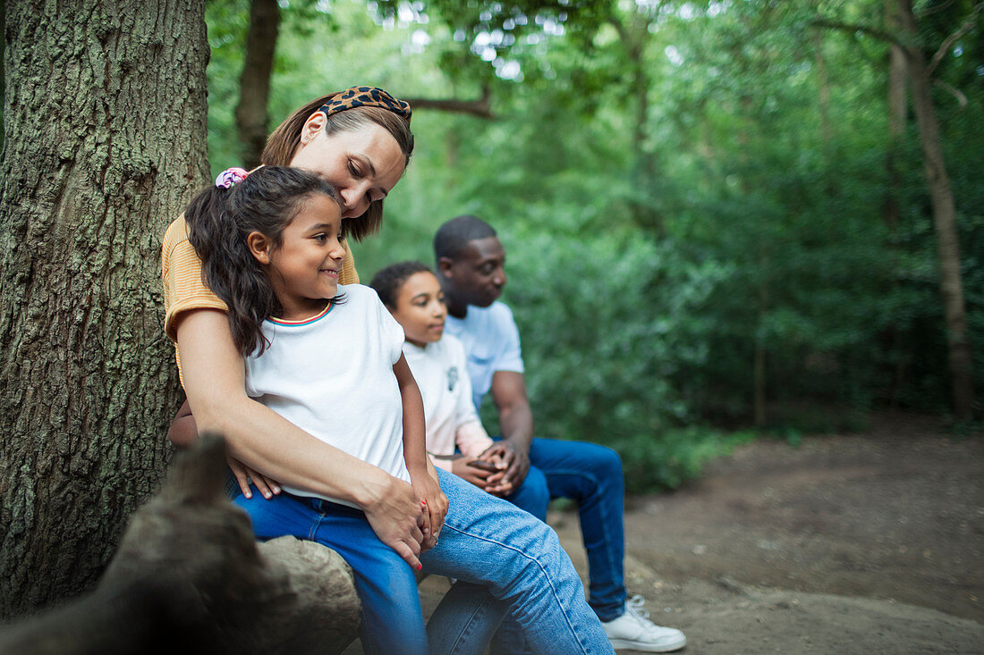 Happy family resting on hike in woods