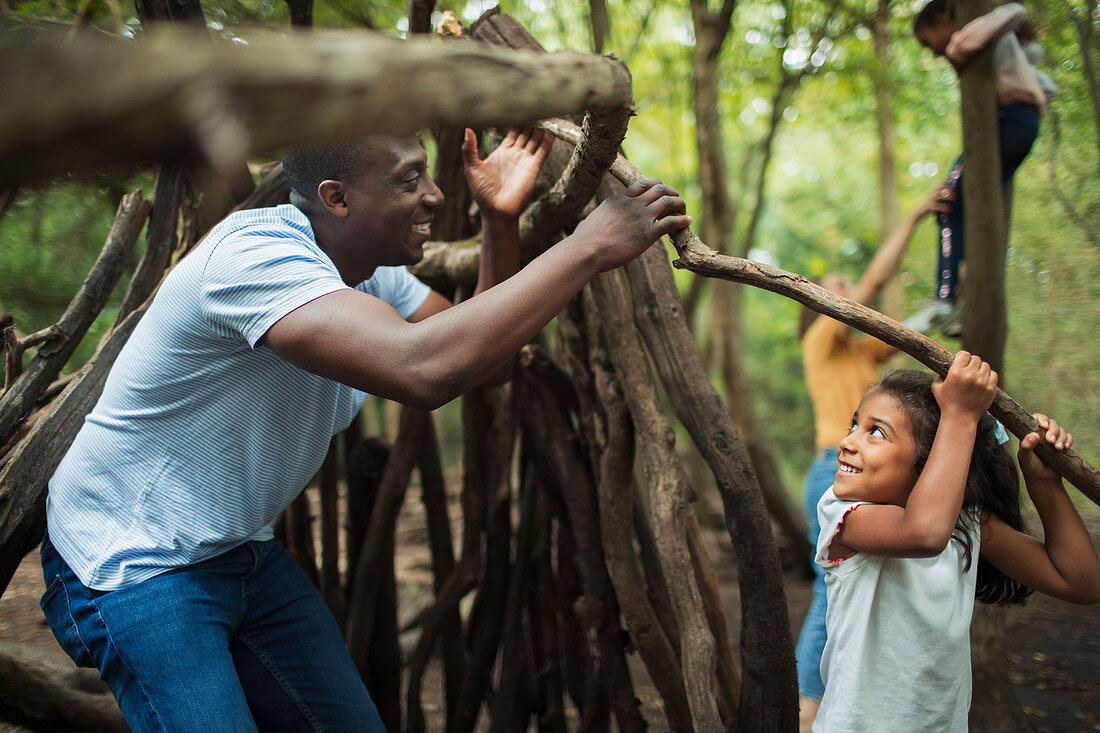 Father and daughter building teepee