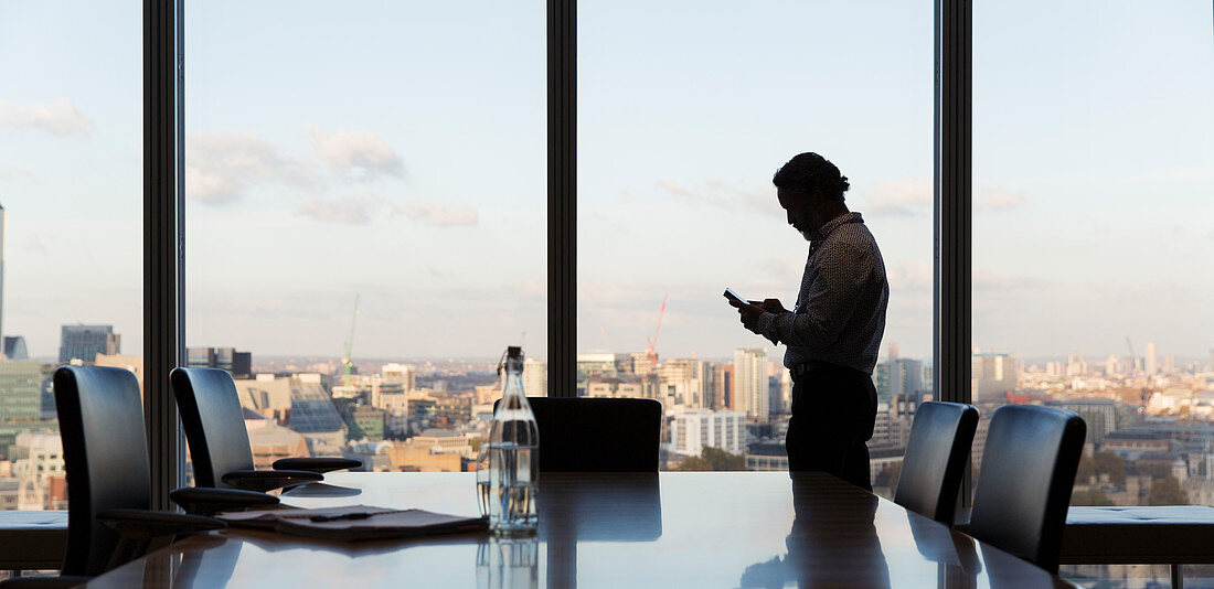 Businessman using smart phone, London, UK