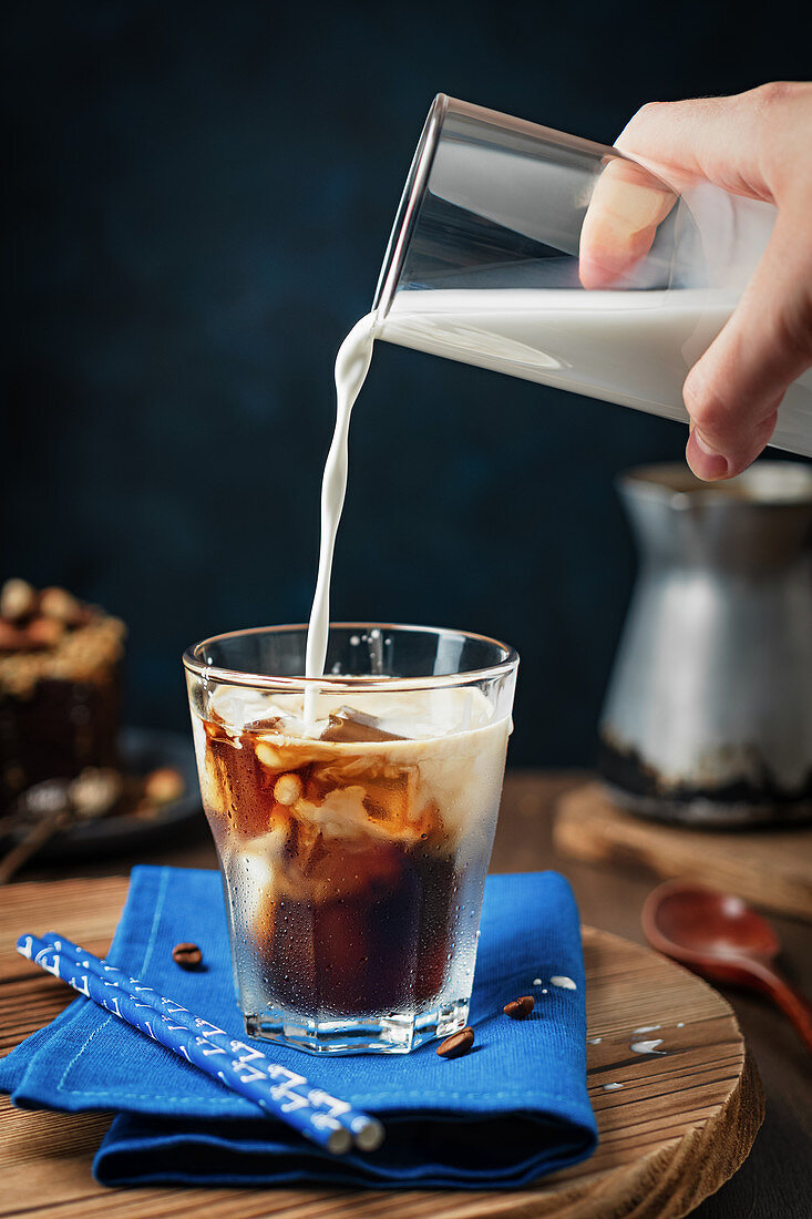 Milch in Eiskaffee giessen