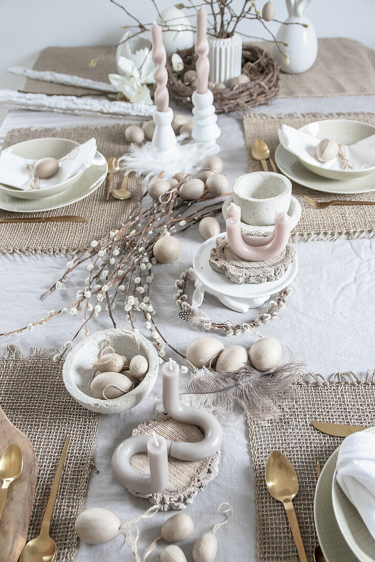 Artistically twisted and curved candles on table set for Easter meal