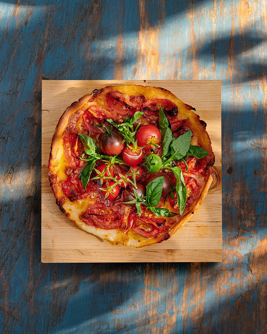 Pizza with tomatoes and fresh herbs