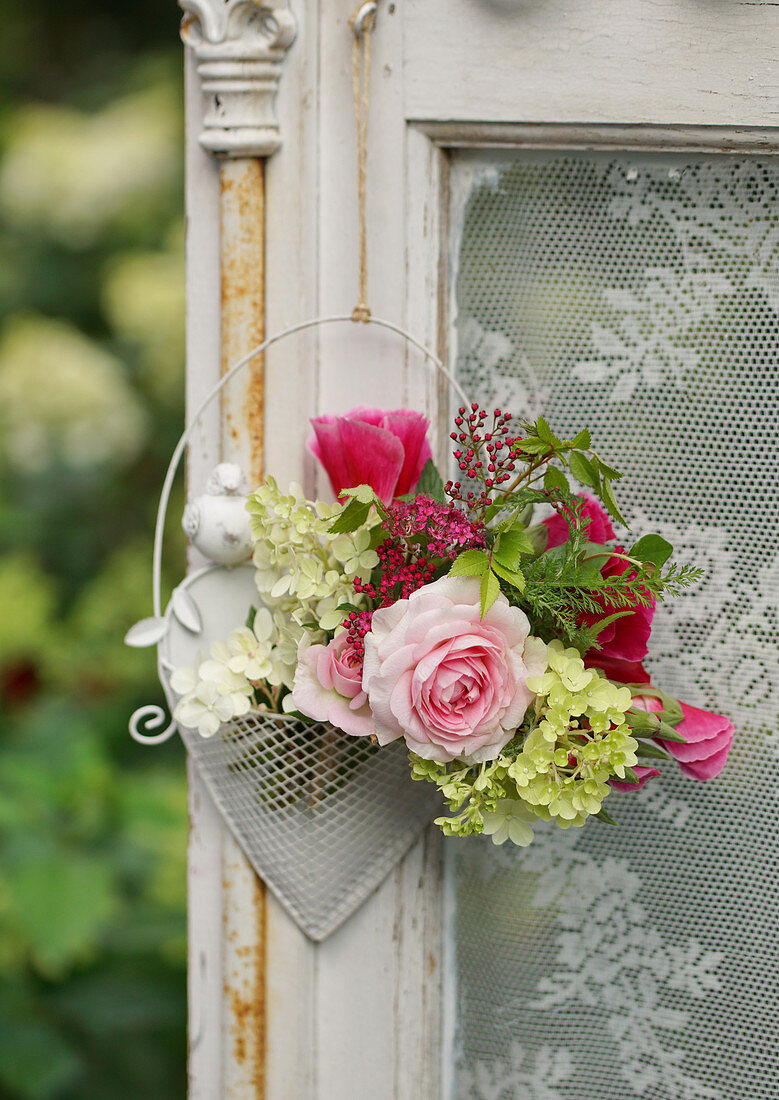 A small bouquet of rose petals, hydrangea and meadowsweets