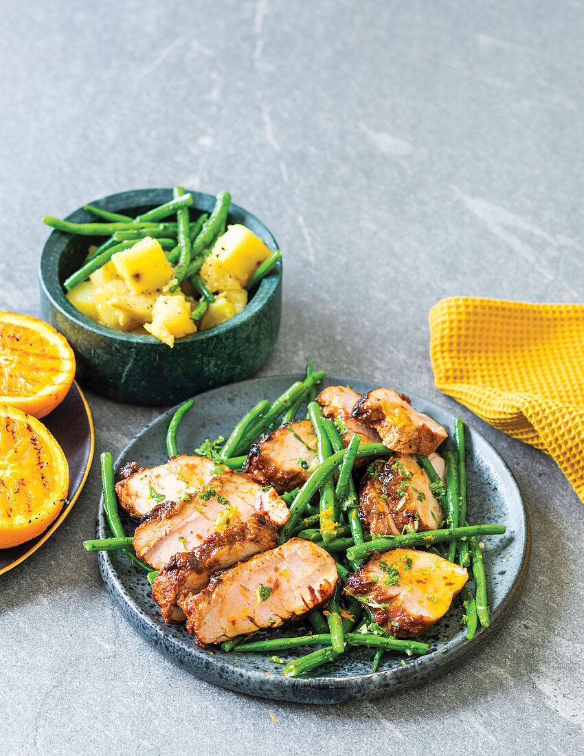 Harissa pork fillet with sweet potato and garlicky beans