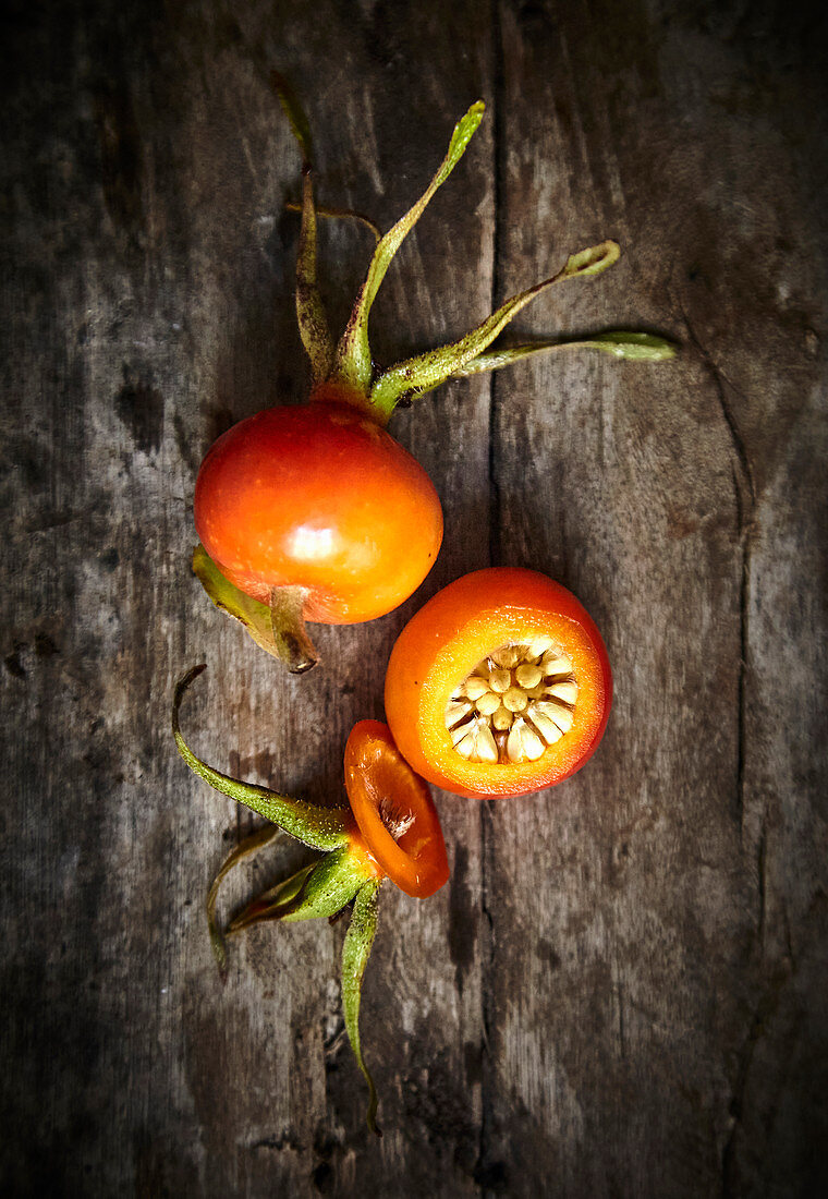 Rose hips on wooden background