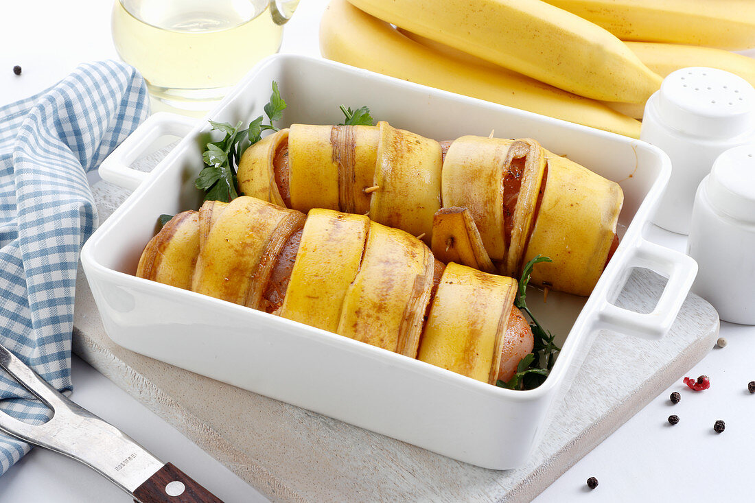 Chicken breasts prepared for baking in banana peels