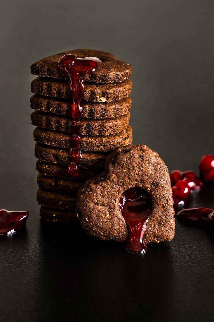 Chocolate and almond heart shaped cookies with cranberry syrup