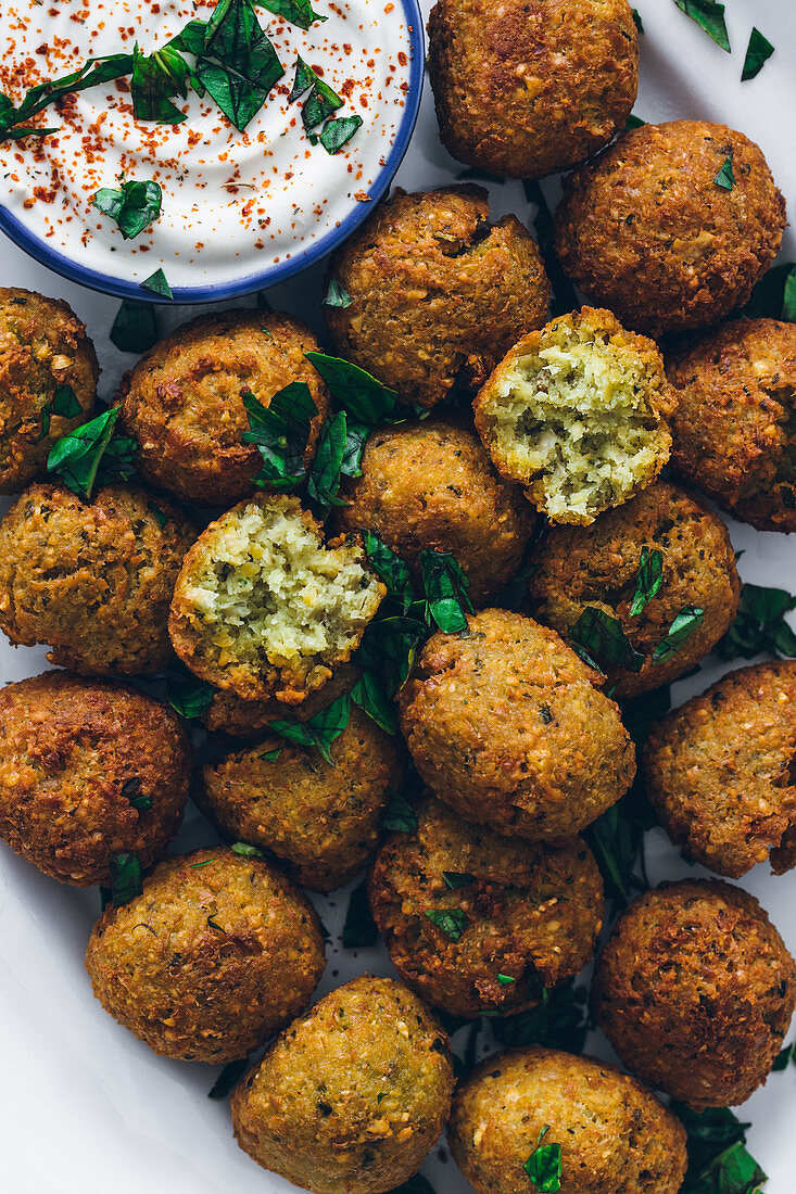 Fried falafel made of legumes served with sour cream sauce