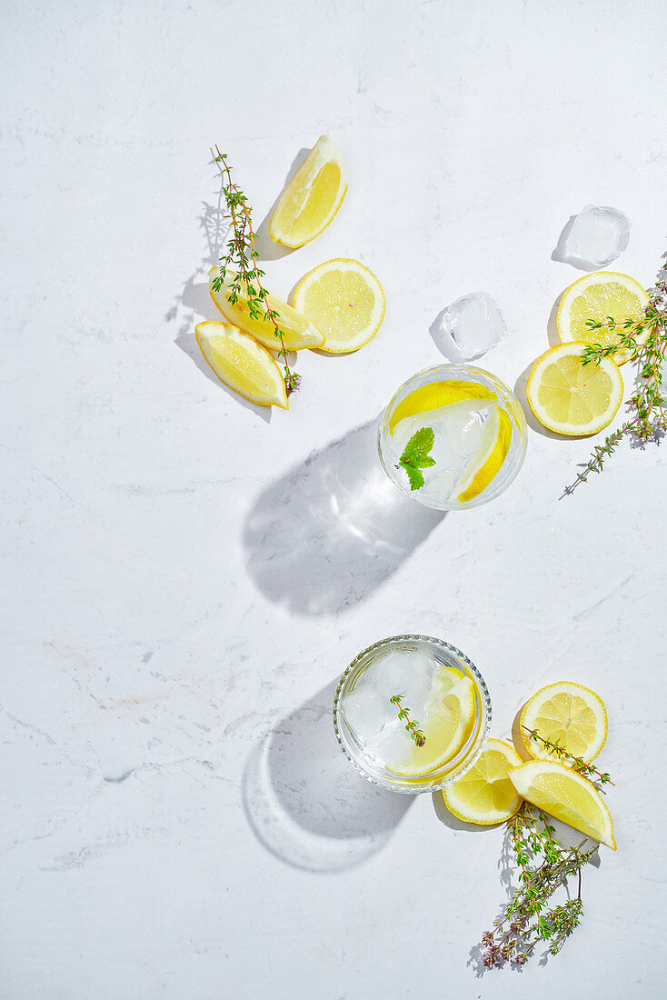 Glasses with refreshing cold thyme and ginger lemonade