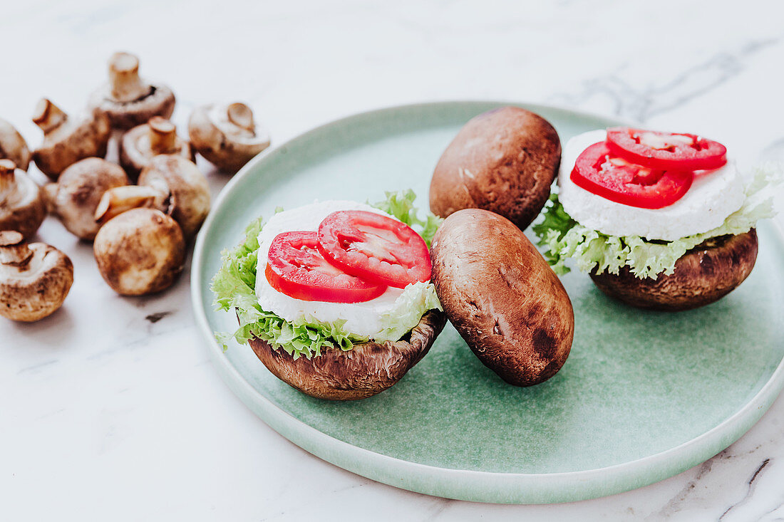 Mushrooms stuffed with lettuce and cheese with tomato slices