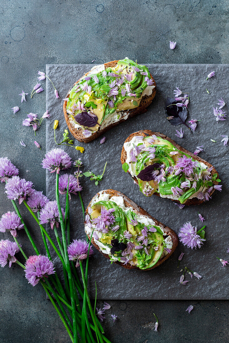 Chive and avocado topped bread slices