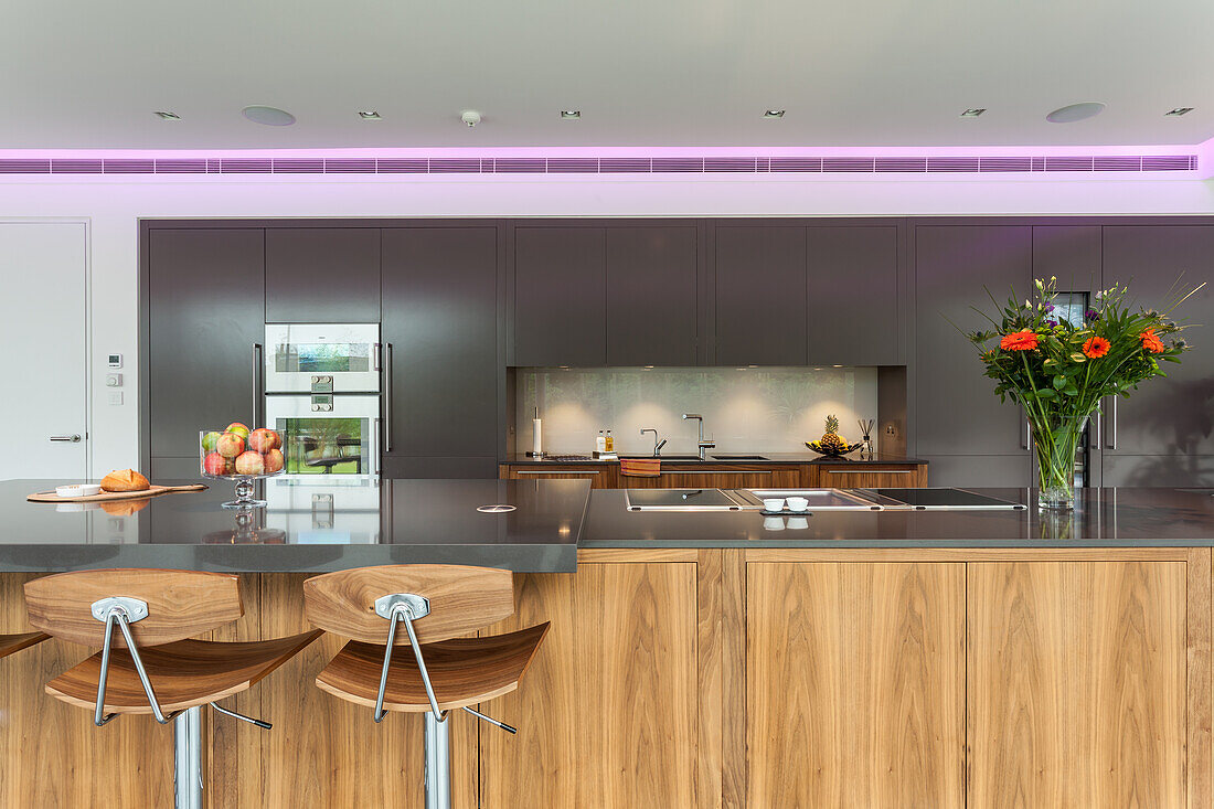 A view over a kitchen island of a fitted kitchen