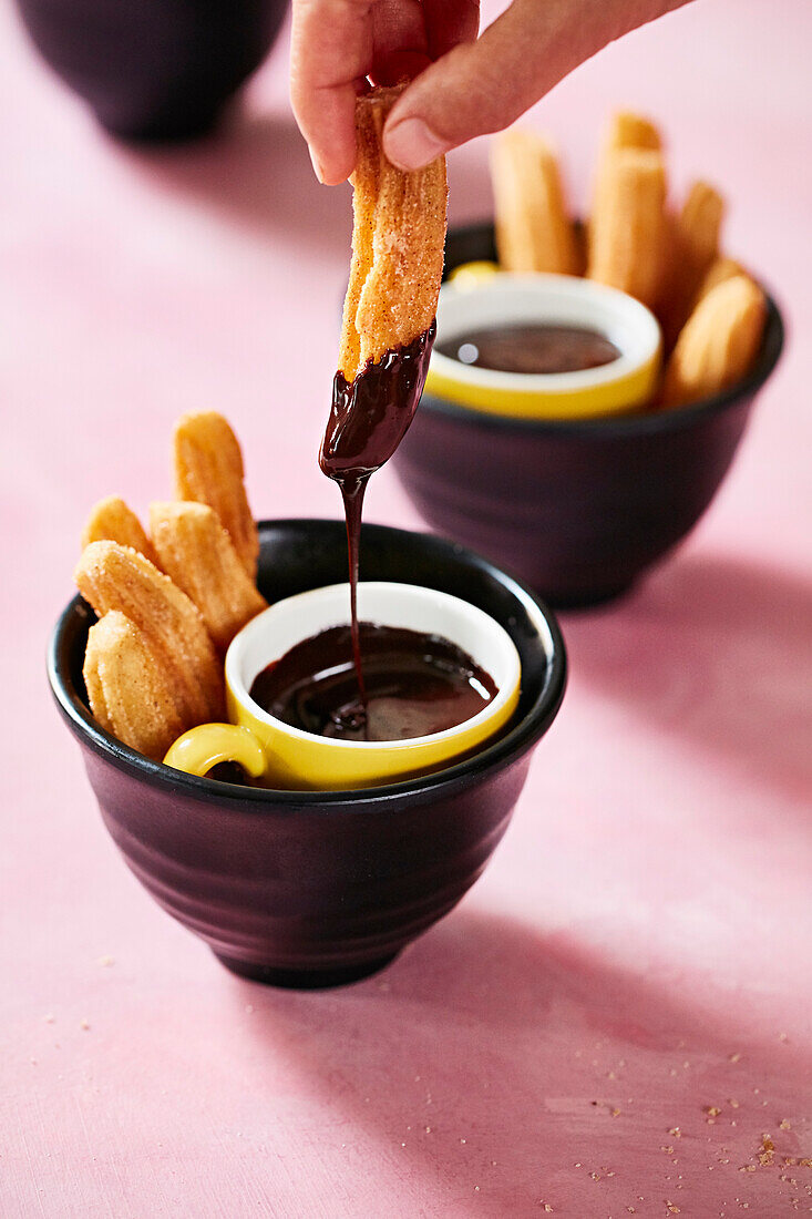 Churros dipped in chocolate sauce