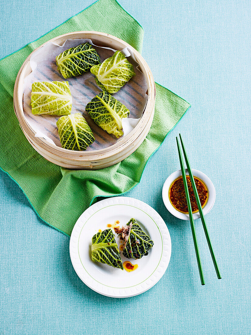 Steamed savoy cabbage parcels made in a bamboo basket