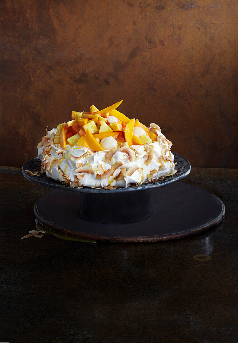 Coconut pavlova with tropical fruits and passion fruit cream