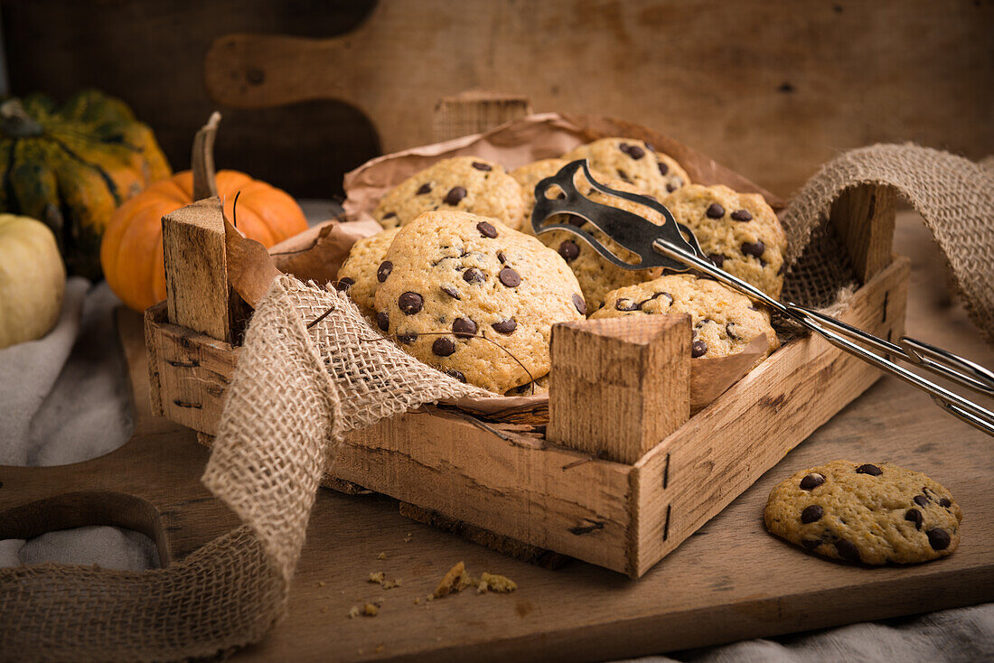 Vegan pumpkin-and-chocolate-chip cookies in a rustic wooden box