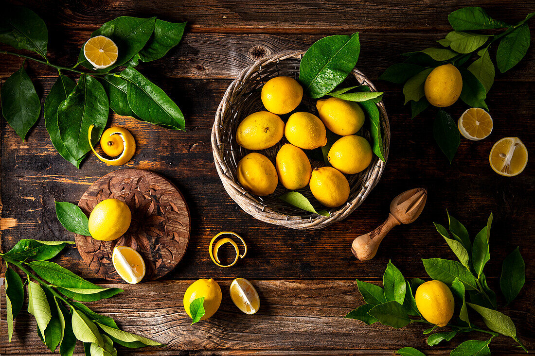Meyer lemons with leaves on rustic wooden table