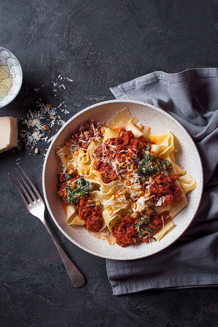 Papardelle with beef in tomato sauce, basil pesto, pine nuts and Parmesan cheese