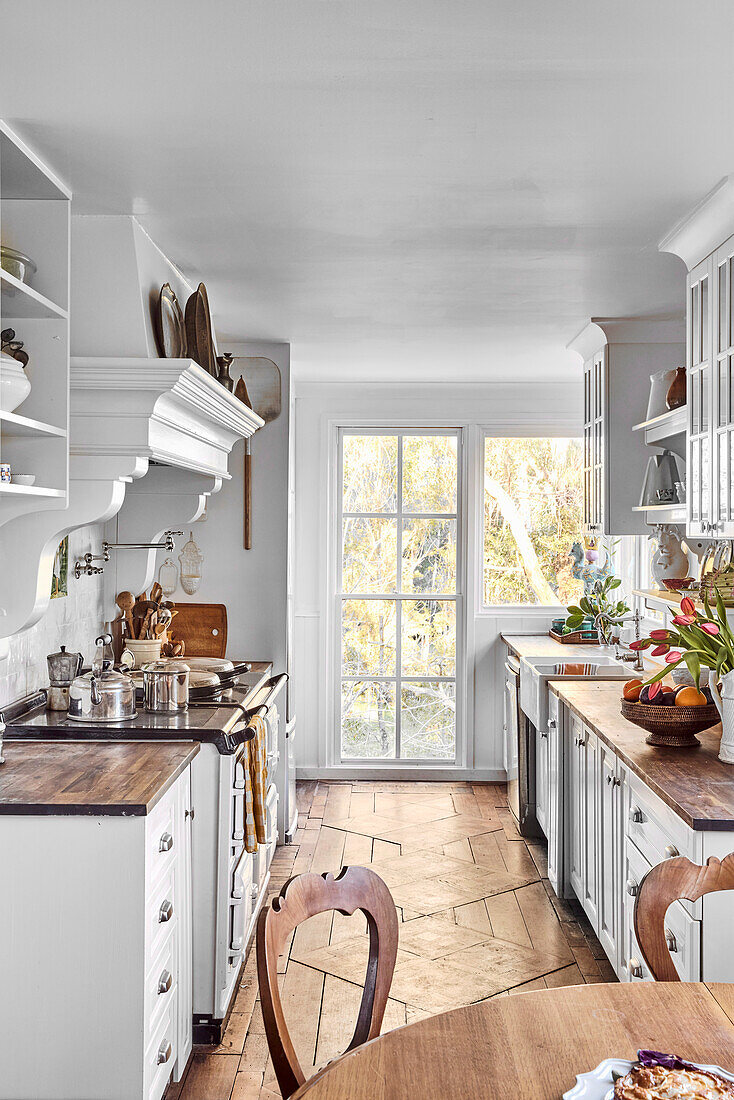 Narrow, light kitchen with wooden worktop