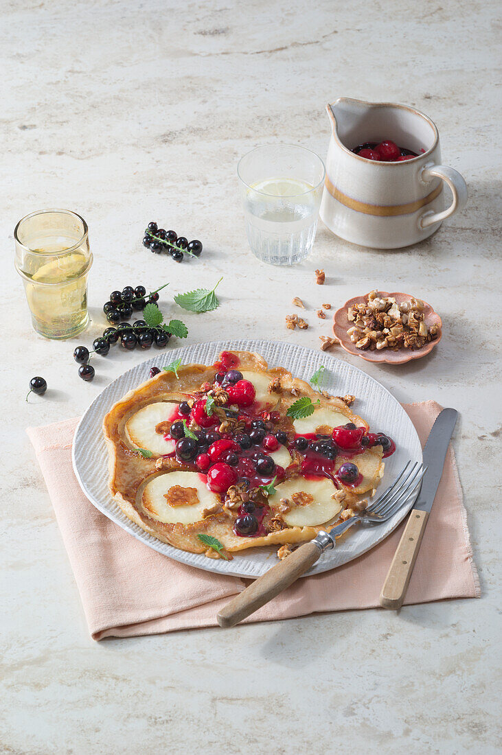 Apple and oatmeal pancakes with berry compote